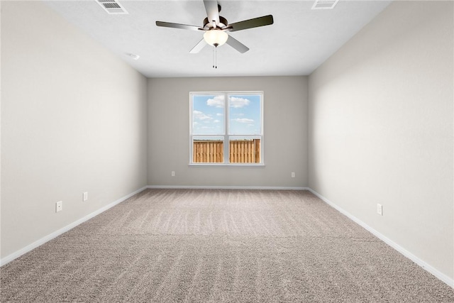 spare room with a ceiling fan, carpet, visible vents, and baseboards