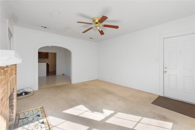 unfurnished living room with ceiling fan and light carpet