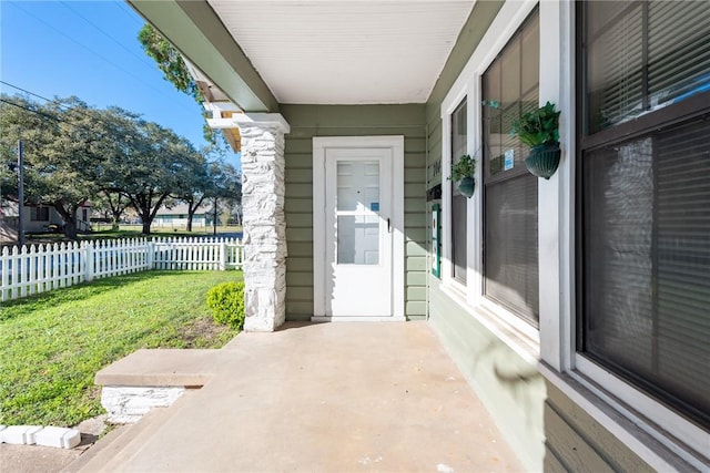 entrance to property featuring a yard