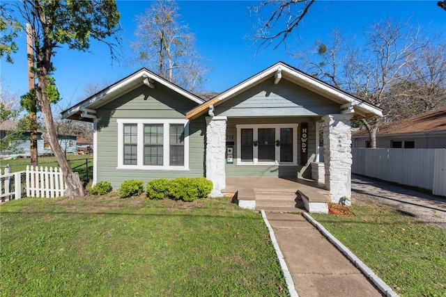 bungalow-style house with a front yard and a porch