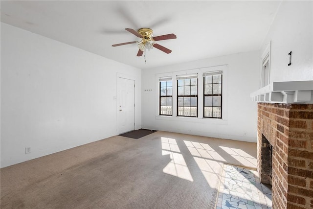 unfurnished living room featuring ceiling fan, light colored carpet, and a fireplace