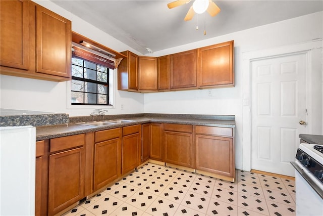 kitchen featuring white range with electric stovetop, ceiling fan, and sink