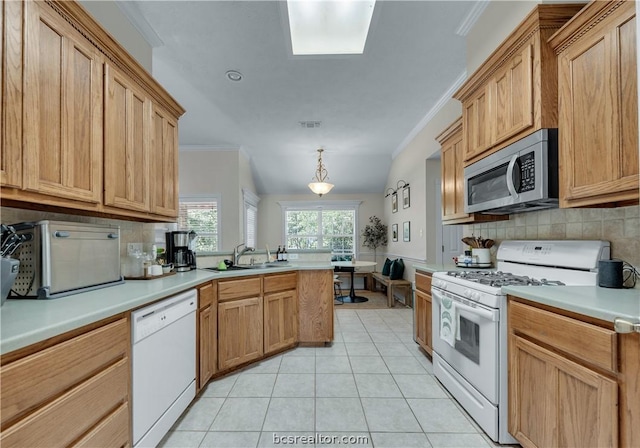 kitchen featuring backsplash, sink, decorative light fixtures, and white appliances