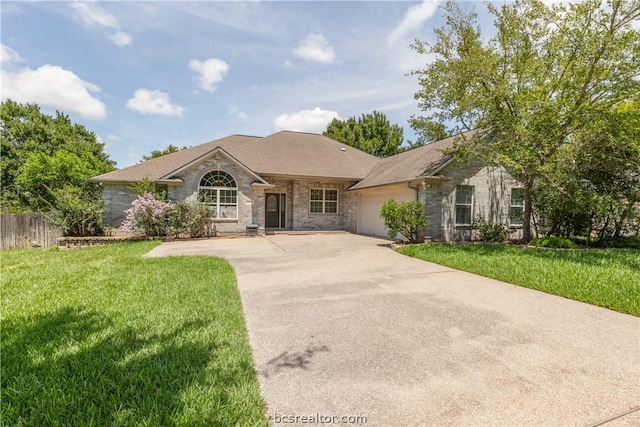 single story home with a front yard and a garage