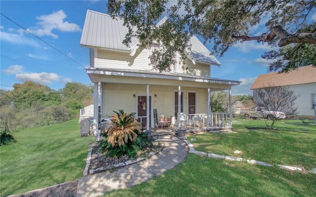 view of front of home featuring covered porch and a front yard