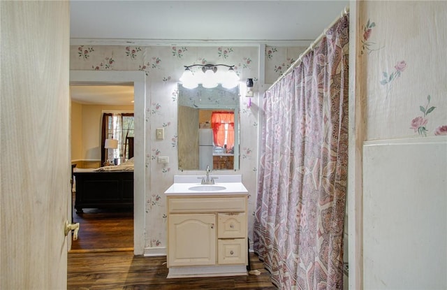 bathroom featuring hardwood / wood-style floors, vanity, and ornamental molding