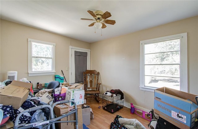 miscellaneous room with hardwood / wood-style flooring, ceiling fan, and a healthy amount of sunlight