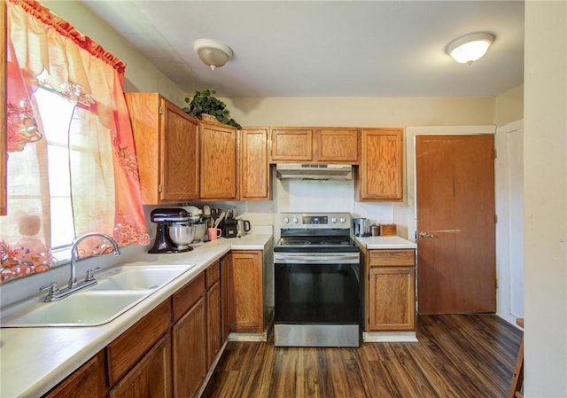 kitchen featuring stainless steel electric range, dark hardwood / wood-style flooring, and sink