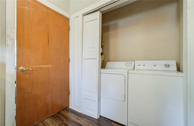 laundry room featuring dark hardwood / wood-style floors and washing machine and dryer