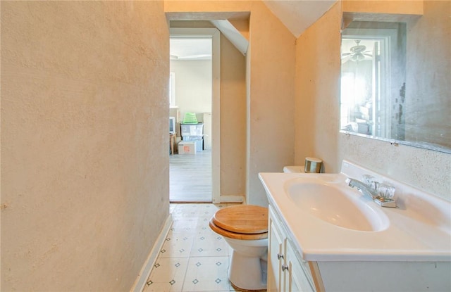 bathroom with vanity, ceiling fan, and toilet