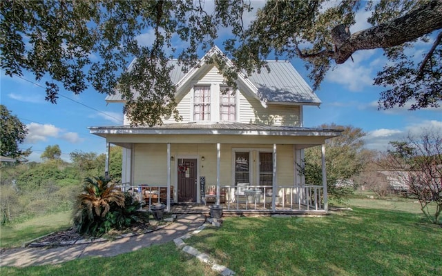 view of front of property with covered porch and a front yard