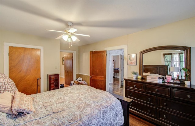 bedroom with dark hardwood / wood-style flooring and ceiling fan