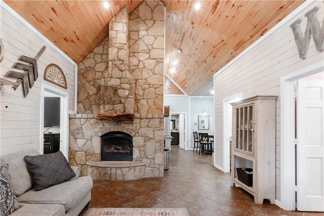 living room with a fireplace, high vaulted ceiling, wooden walls, and wood ceiling