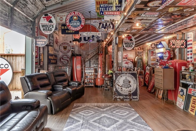 interior space with wood walls, hardwood / wood-style floors, and vaulted ceiling