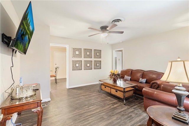 living area featuring a ceiling fan, baseboards, visible vents, and wood finished floors