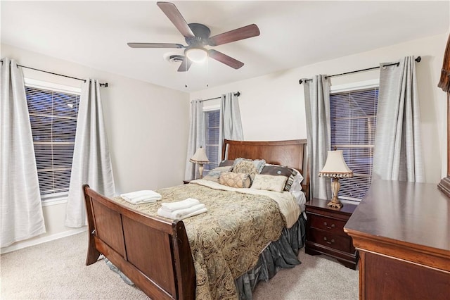 bedroom featuring light colored carpet and ceiling fan