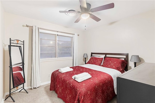 bedroom with carpet, baseboards, and a ceiling fan