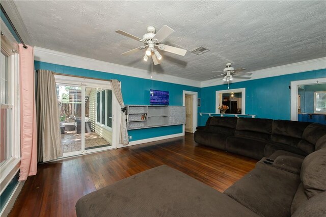 1004 S Magnolia St, Hearne, TX 77859 - living room featuring a textured ceiling, hardwood / wood-style flooring, ceiling fan, and ornamental molding