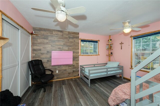 1004 S Magnolia St, Hearne, TX 77859 - sitting room with ceiling fan, healthy amount of natural light, wood finished floors, and wood walls