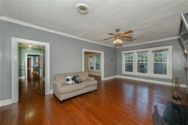 1004 S Magnolia St, Hearne, TX 77859 - living room with hardwood / wood-style flooring, a ceiling fan, a textured ceiling, and ornamental molding