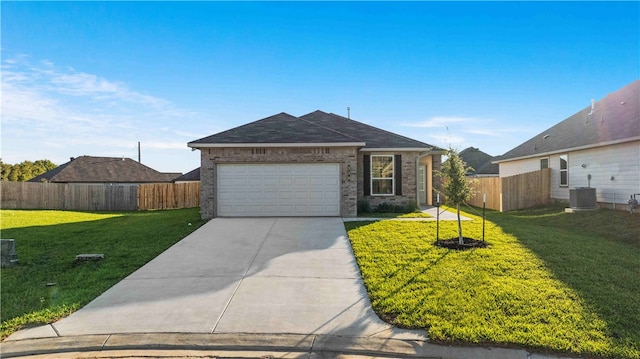 ranch-style house featuring a front lawn, a garage, and central AC unit