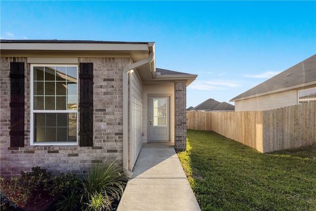 doorway to property with a yard