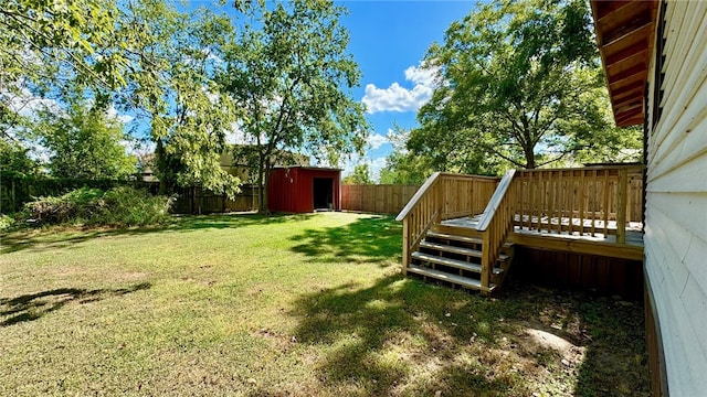 view of yard featuring a storage shed and a wooden deck