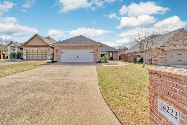 single story home with brick siding, a shingled roof, concrete driveway, a front yard, and a garage