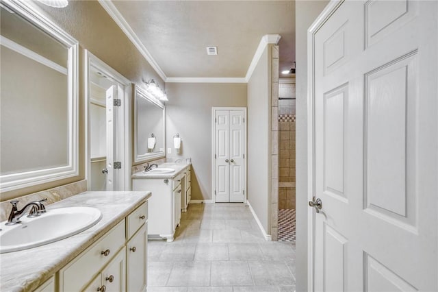 bathroom with a sink, tiled shower, two vanities, and ornamental molding