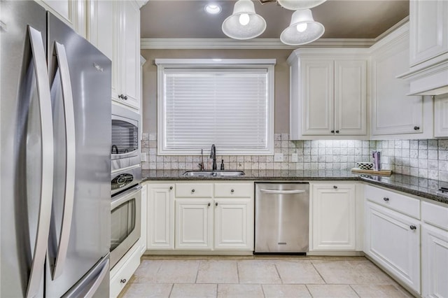 kitchen with backsplash, crown molding, stainless steel appliances, white cabinetry, and a sink