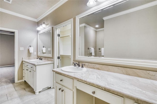 bathroom featuring ornamental molding, two vanities, visible vents, and a sink