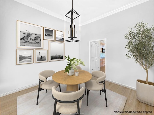 dining area featuring light hardwood / wood-style floors, an inviting chandelier, and ornamental molding