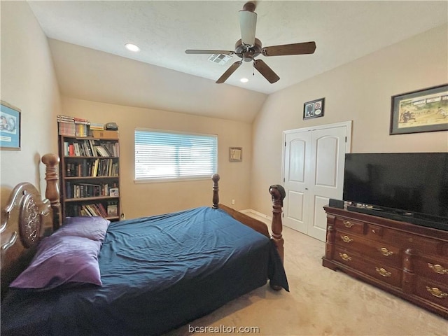 carpeted bedroom featuring ceiling fan, a closet, and vaulted ceiling