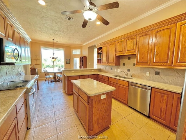 kitchen featuring decorative backsplash, appliances with stainless steel finishes, sink, decorative light fixtures, and a center island