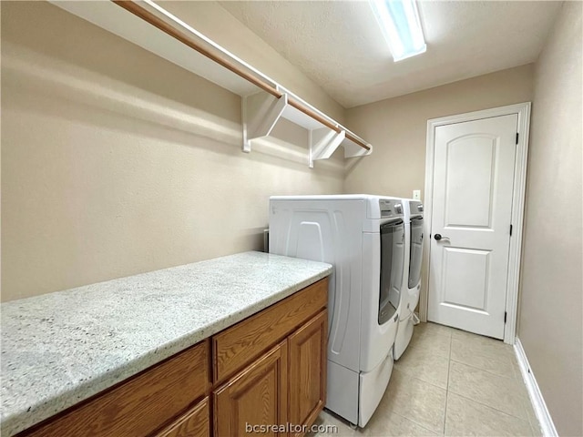 laundry room featuring independent washer and dryer and light tile patterned floors