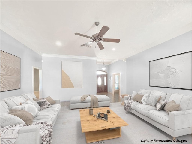 living room with ceiling fan and crown molding