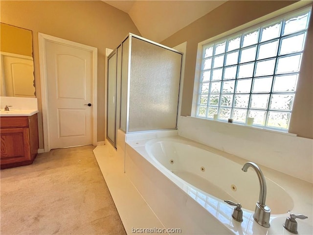 bathroom featuring vaulted ceiling, a wealth of natural light, and independent shower and bath