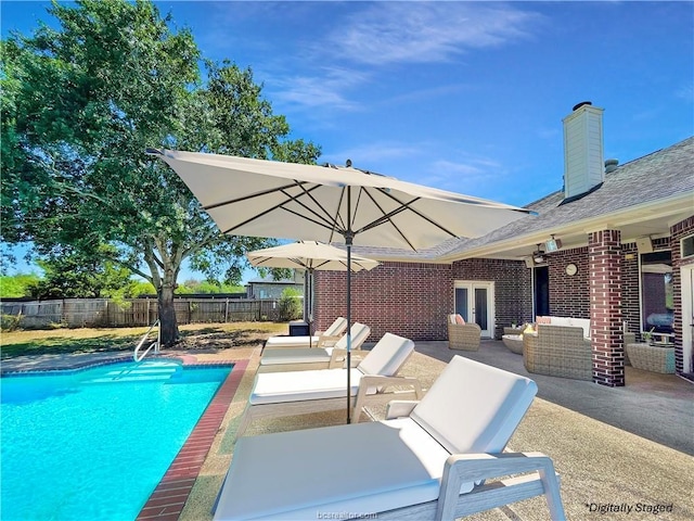 view of pool featuring an outdoor living space, a patio, and french doors