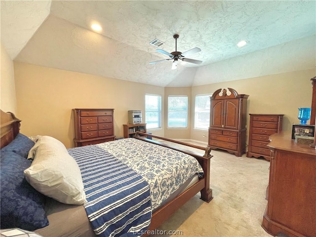 bedroom with light carpet, a textured ceiling, ceiling fan, and lofted ceiling