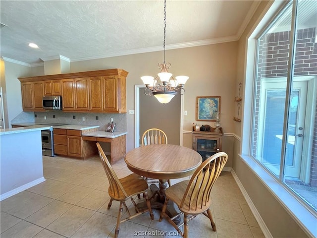 tiled dining space with crown molding and a chandelier