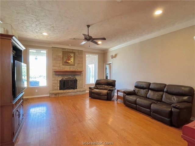 unfurnished living room featuring a textured ceiling, hardwood / wood-style flooring, ceiling fan, and ornamental molding