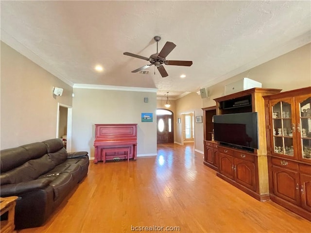 living room featuring light hardwood / wood-style flooring, ceiling fan, and ornamental molding