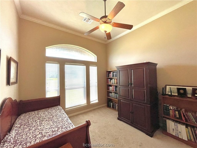 carpeted bedroom featuring ceiling fan and crown molding