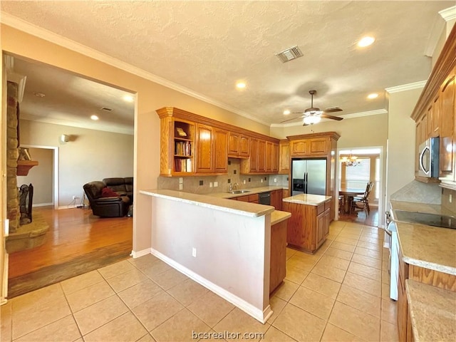 kitchen with a kitchen island, ornamental molding, appliances with stainless steel finishes, light tile patterned flooring, and kitchen peninsula