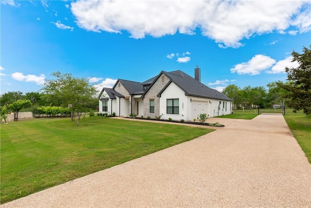 view of front of home with a front lawn and a garage