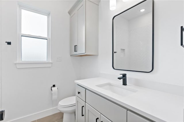 bathroom featuring tile patterned flooring, vanity, and toilet