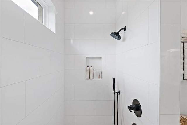 bathroom with a tile shower