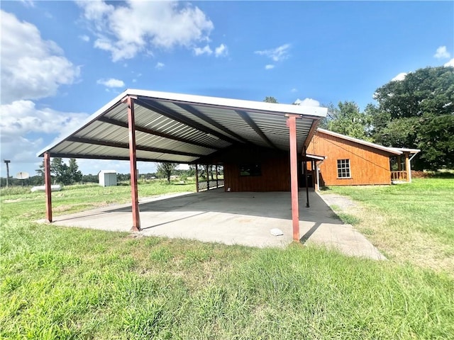 view of vehicle parking with a lawn and a carport