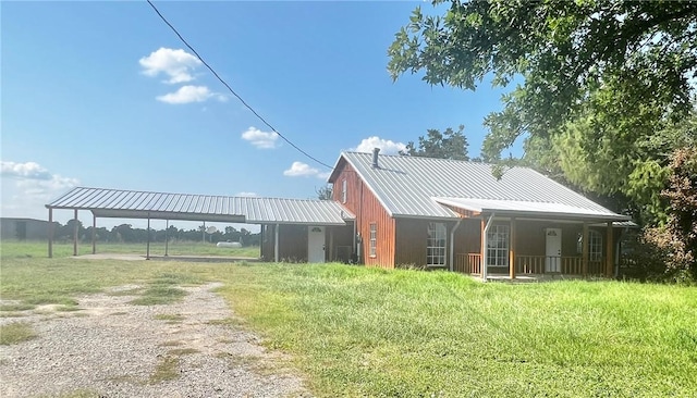 back of house with a porch and a carport