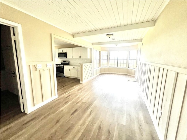 interior space with beam ceiling, wooden ceiling, and light hardwood / wood-style floors